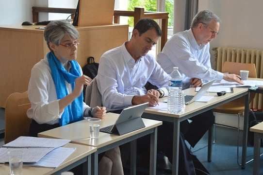 SIOE conference photo: Emily Kadens, Benito Arrunada, and Scott Masten at the conference.