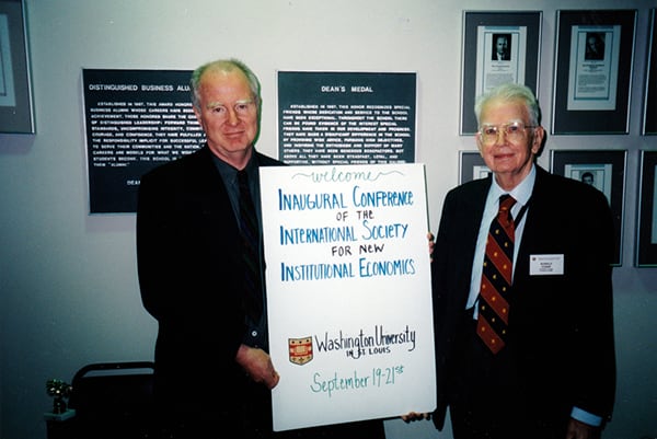 SIOE conference photo: Ronald Coase (right) with conference organizer Lee Benham during the inaugural ISNIE conference 1997 in St. Louis.